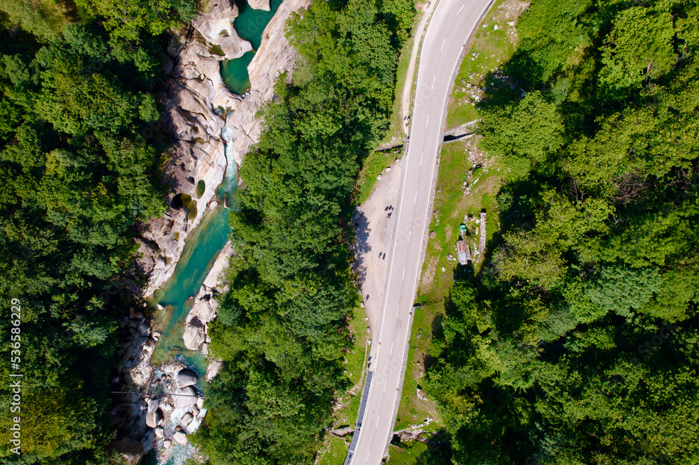 Aerial view of beautiful Verzasca Valley, Canton Ticino, with river, forest, rock and bridge on a hot sunny summer day. Photo taken July 26th, 2022, Lavertezzo, Switzerland.