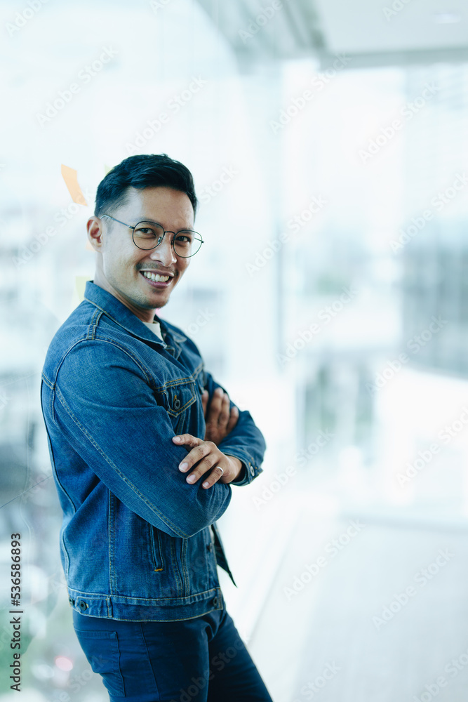 Asian male business owner smiling in front, showing his success in business investment Asian male business owner smiling in front, showing his success in business investment