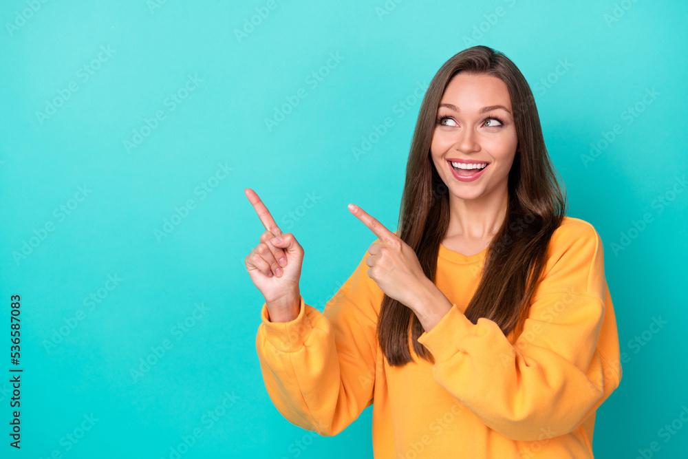 Photo of positive lady promoter indicate incredible advert offer isolated on cyan color background Photo of positive lady promoter indicate incredible advert offer isolated on cyan color background