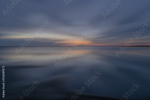 Intentional camera movement on a lake during sunset.