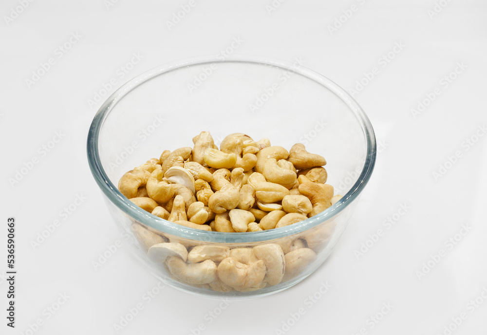 roasted cashews nuts in a transparent glass bowl closeup roasted cashews nuts in a transparent glass bowl closeup