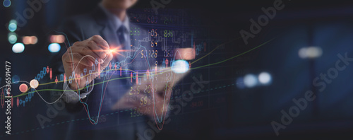 Businessman touching on investment growth graph chart and analysing stock market data trading and forex graph currency exchange, Stock market report, Business, world economy, finance and investment  photo