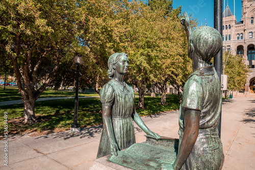 Children sculpture at entrance of Salt Lake City and County Building. Bronze artistic statues against trees. Beautiful creativity at famous landmark during sunny day. photo
