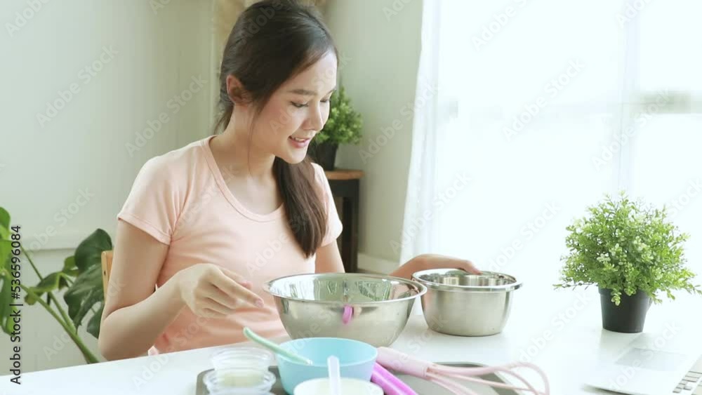 Young asian woman sits and learns how to make fresh milk ice cream from her laptop step by step emphasizing the sweetness and deliciousness of fresh ingredients happily wonderful atmosphere at home.
Young asian woman sits and learns how to make fresh milk ice cream from her laptop step by step emphasizing the sweetness and deliciousness of fresh ingredients happily wonderful atmosphere at home.