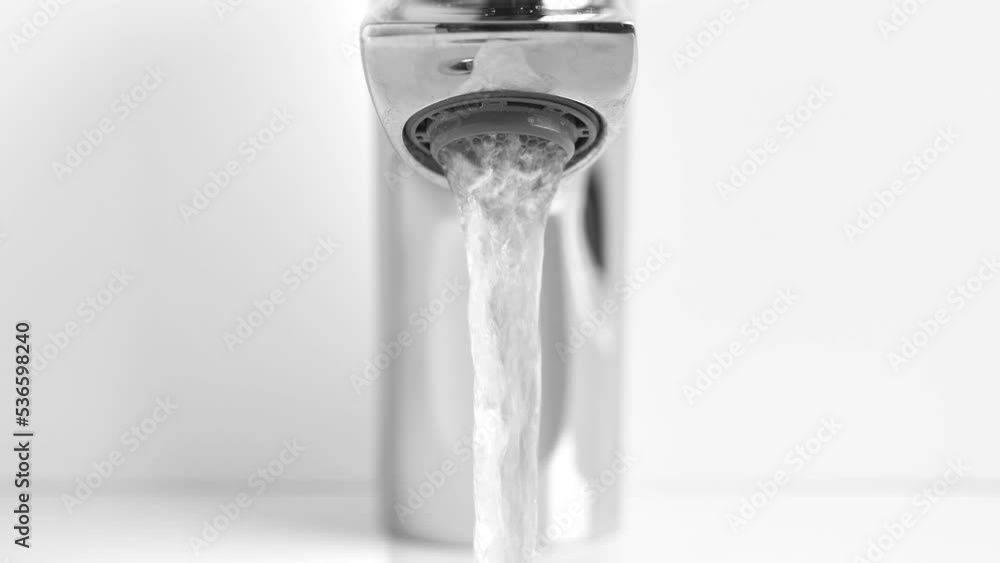 Water running from Faucet tap in white sink. Nobody Water running from Faucet tap in white sink. Nobody