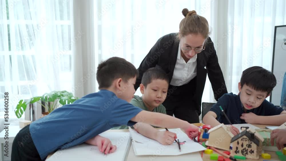 Group of little boys and girls enjoy drawing and painting together in classroom. Group of little boys and girls enjoy drawing and painting together in classroom.