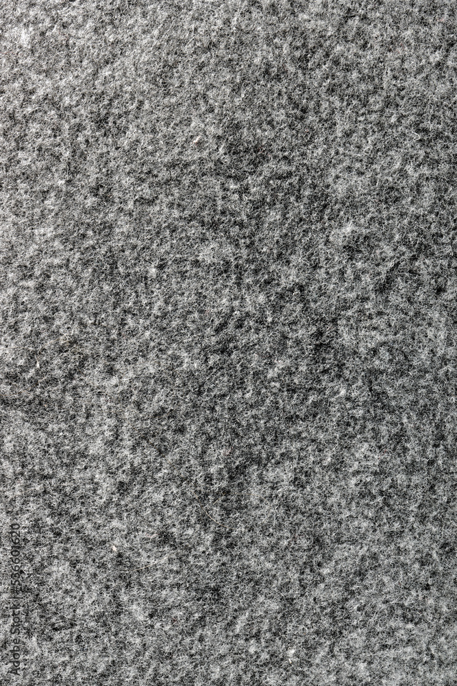 Gray felt textile material close-up background texture with copy space.