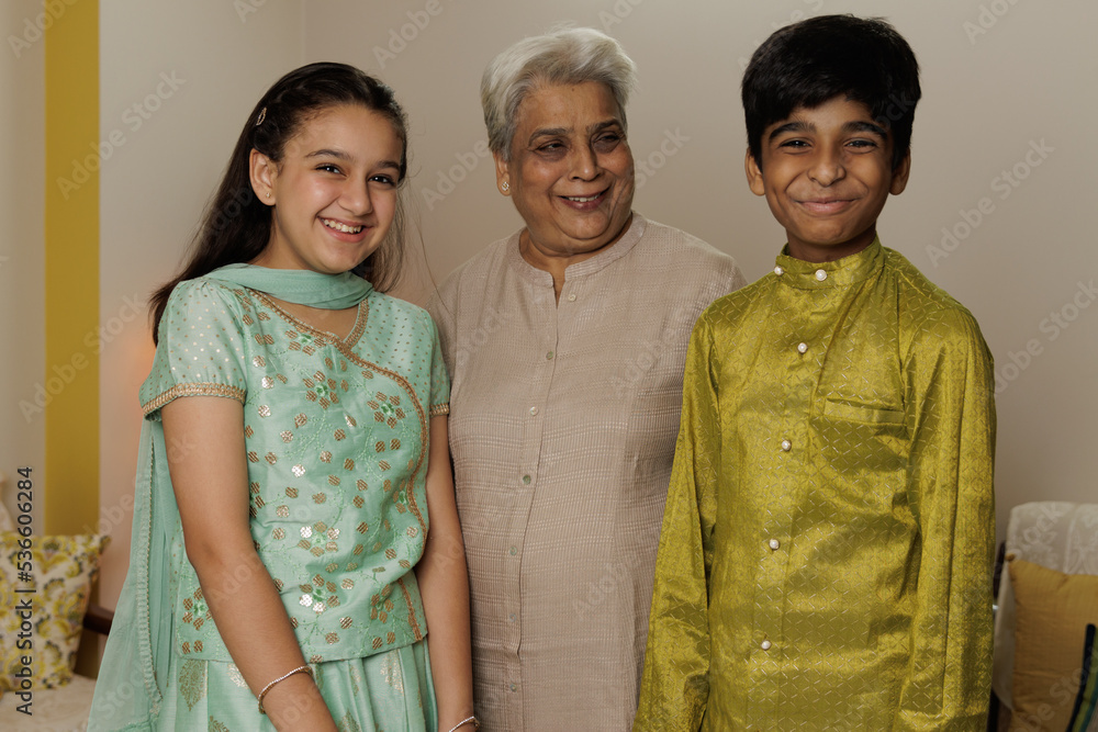 Young girl and boy, kids, dressed up in ethnic wear standing along with ...