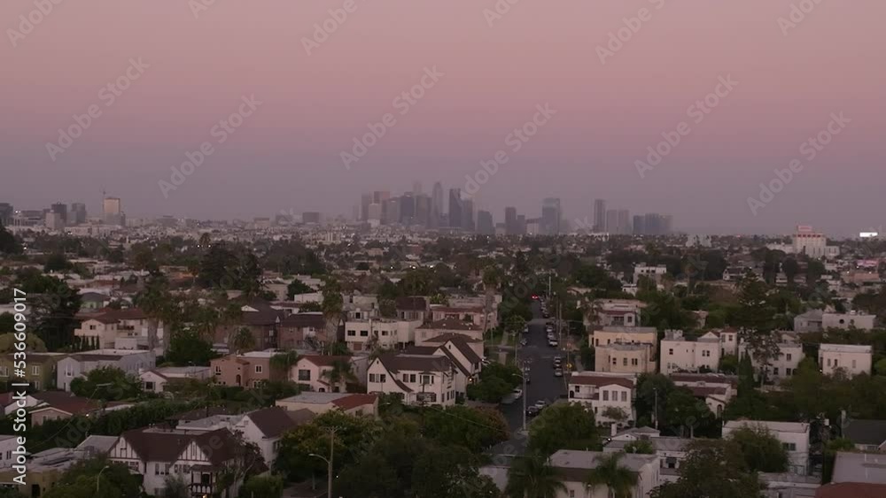 Los Angeles hot sunset view with palm tree and downtown in background. California, USA theme - background. Art videography Los Angeles hot sunset view with palm tree and downtown in background. California, USA theme - background. Art videography