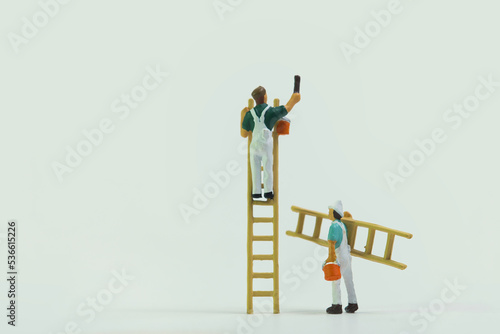 Painter with ladder at work isolated on white background