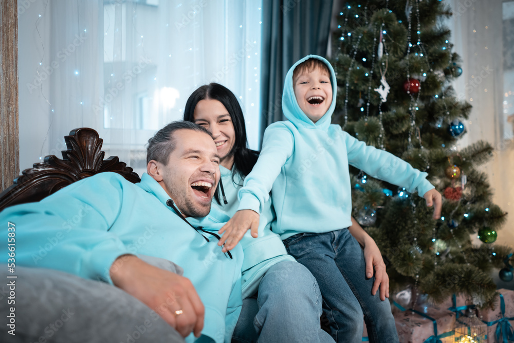 happy family with mother father and son have fun on christmas decorating tree happy family with mother father and son have fun on christmas decorating tree