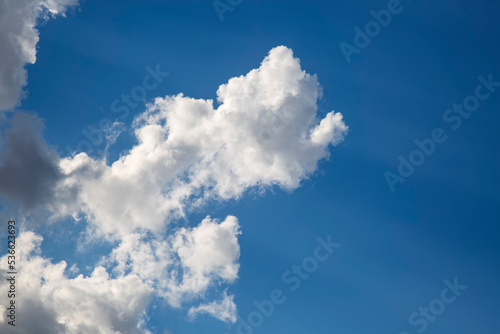 Blue Sky and white cloud during day. Beautiful clear cloudy in sunlight calm season. Cloudy sunny sky in morning. Heaven background with big clouds with soft light from the sun. Photo cloudscape