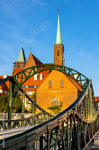 Panoramic view of Ostrow Tumski Island with Holy Cross collegiate cathedral and Most Tumski Bridge over Odra river in historic old town quarter of Wroclaw in Poland