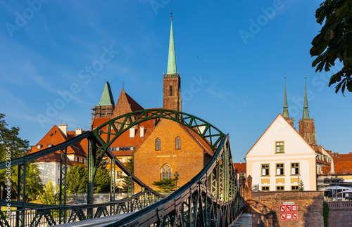 Panoramic view of Ostrow Tumski Island with Holy Cross collegiate cathedral and Most Tumski Bridge over Odra river in historic old town quarter of Wroclaw in Poland
