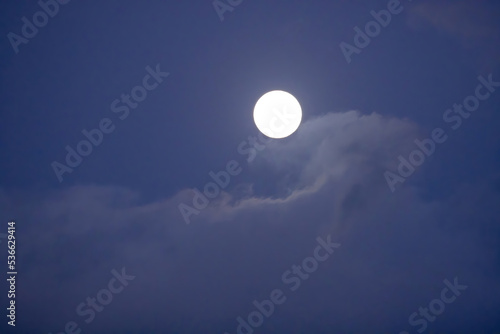Moon in the sky with a cloud