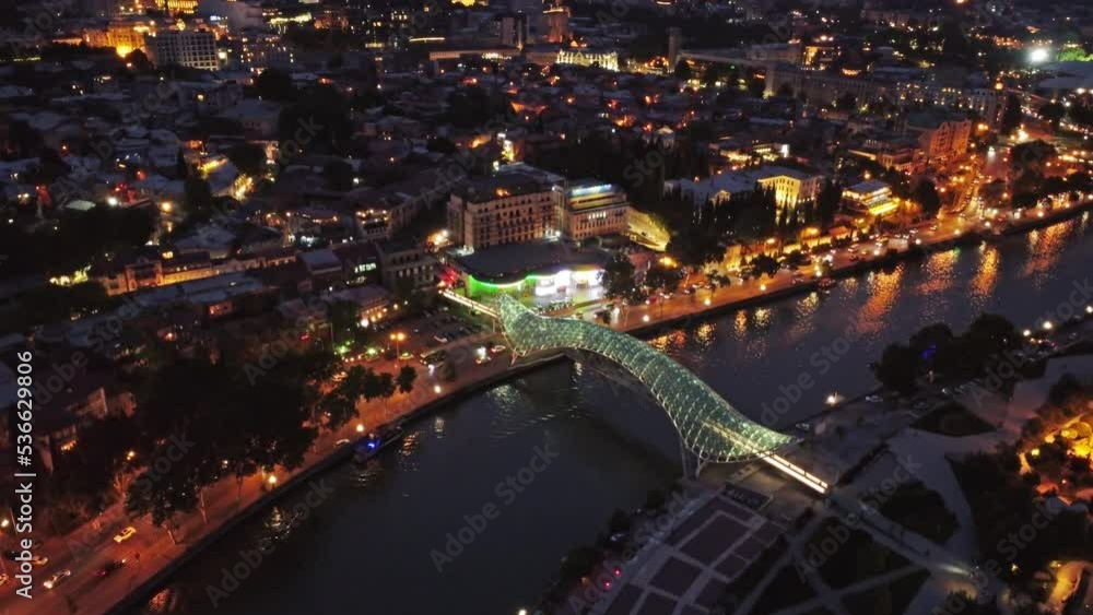 Aerial view of the Kura river and the Bridge of Peace at night in Tbilisi, Georgia, 4k Aerial view of the Kura river and the Bridge of Peace at night in Tbilisi, Georgia, 4k