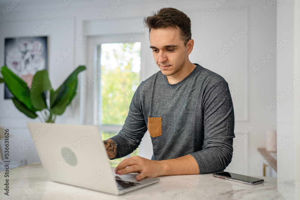 one man caucasian male use laptop computer in the morning one man caucasian male use laptop computer in the morning