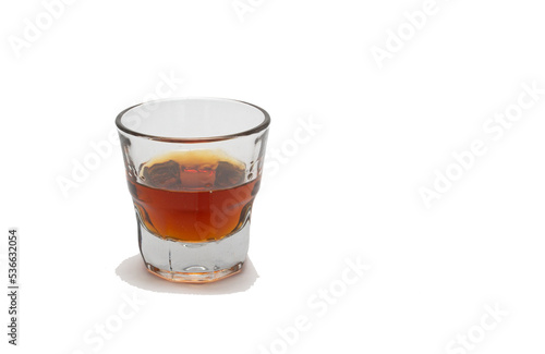 Whiskey in a shot glass on white background