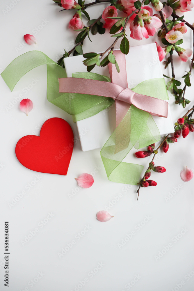 greeting card happy valentine's day. blooming spring azalea branch and red heart