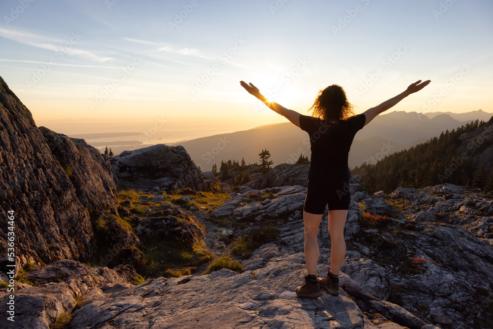 Adventurous Woman Hiker on top of Canadian Mountain Landscape. Sunny Sunset Sky. Top of Mt Seymour near Vancouver, British Columbia, Canada. Adventure Travel Concept Adventurous Woman Hiker on top of Canadian Mountain Landscape. Sunny Sunset Sky. Top of Mt Seymour near Vancouver, British Columbia, Canada. Adventure Travel Concept