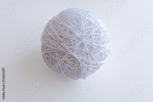 A ball of rope yarn isolated on a white background. Knitted ball of white color