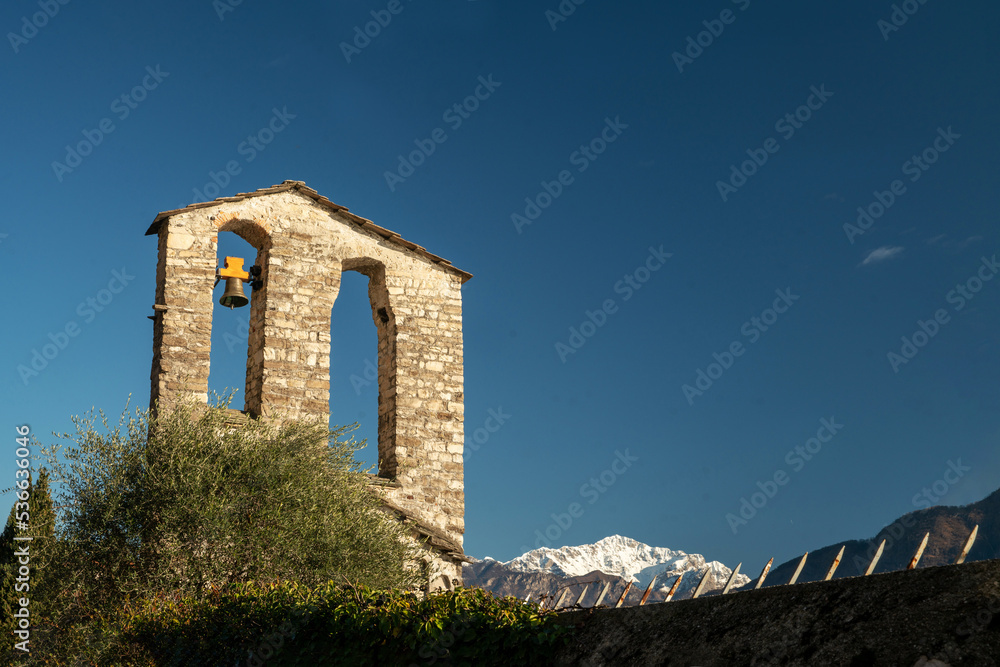 Belfry of  old   church on lake Como in sunny day during Christmas week