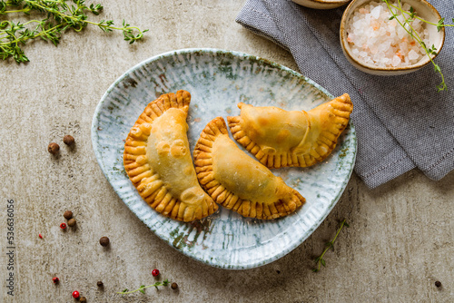 fried mini chebureks on grey wooden table top view photo