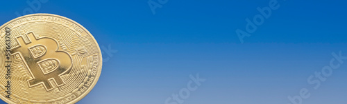 Wallpaper Mural closeup of a bitcoin coin on a blue gradient background, copy space, panoramic, banner horizontal Torontodigital.ca