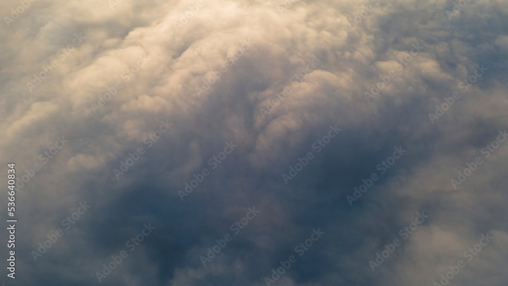 Fototapeta premium Sunrise and Horizon over a clouds, aerial view