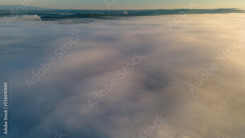 Fototapeta Naklejka Na Ścianę i Meble -  Sun, Early Sunrise and Horizon over a clouds cover mountains ridge