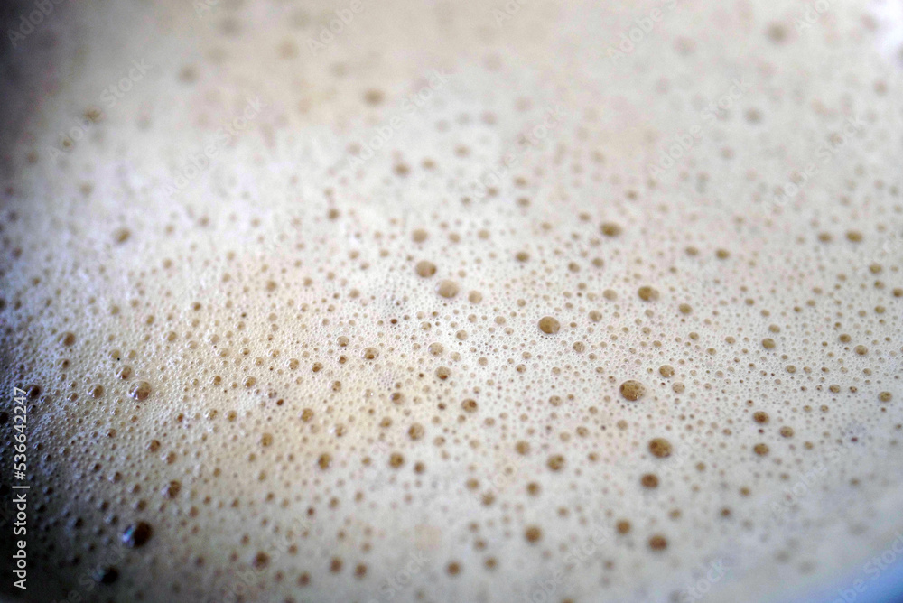 Macro photography of Cappuccino milk foam in a glass Macro photography of Cappuccino milk foam in a glass