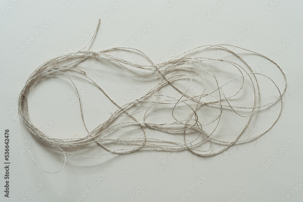 length of brown twine or string on paper length of brown twine or string on paper