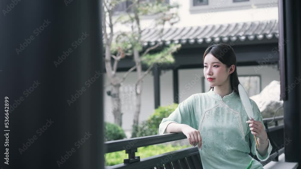 young beautiful chinese woman in qipao in modern luxury yard villa young beautiful chinese woman in qipao in modern luxury yard villa