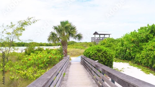Point of view pov walking on wooden boardwalk of Tigertail beach park of Southwest Florida Marco Island with view on Gulf of Mexico lagoon photo