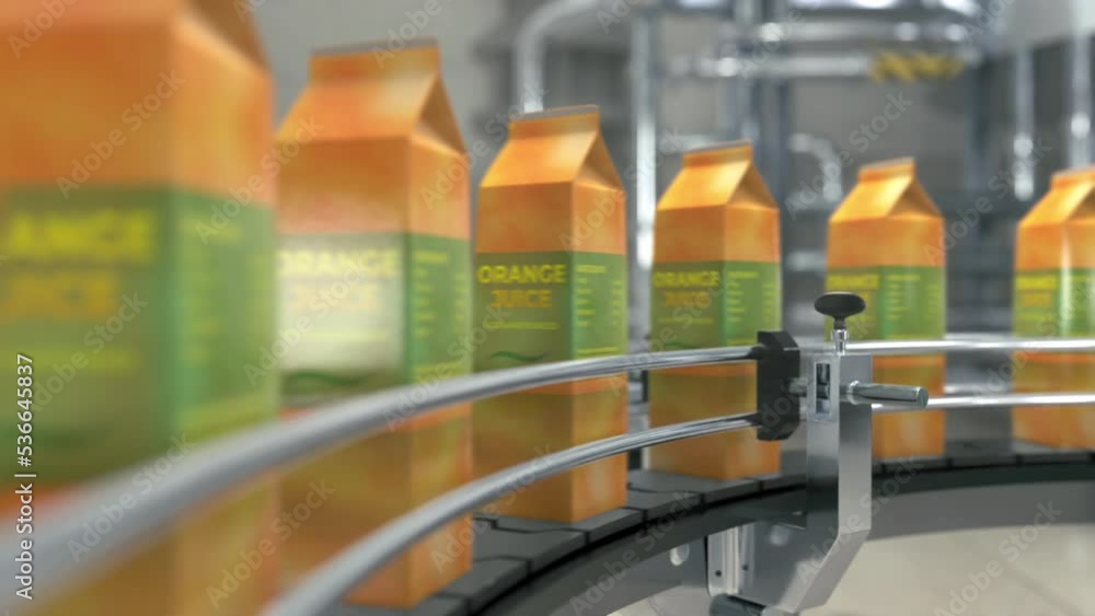 Automated conveyor equipment carrying the orange juice drink at the factory. Drink product progressing through the automated conveyor line. Juice drink in cartons advancing on automated conveyor belt Automated conveyor equipment carrying the orange juice drink at the factory. Drink product progressing through the automated conveyor line. Juice drink in cartons advancing on automated conveyor belt
