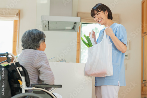 買い物代行をする女性介護士と利用者の女性