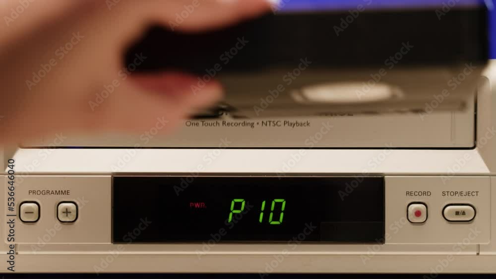 Old video recorder close-up, VHS. Retro player, vintage video cassette broadcasting on blue background, audio tape. Old video recorder close-up, VHS. Retro player, vintage video cassette broadcasting on blue background, audio tape.