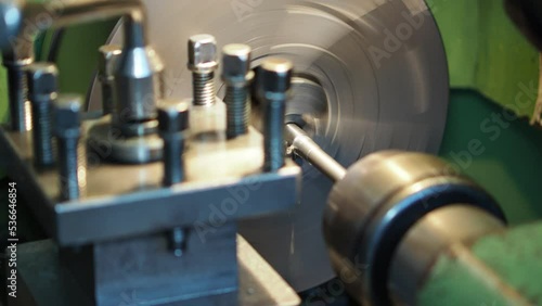 Turning milling combine machine cutting metal workpiece with shavings at factory, plant, exhibition. Metalworking, engraving, industrial, equipment, production, technology