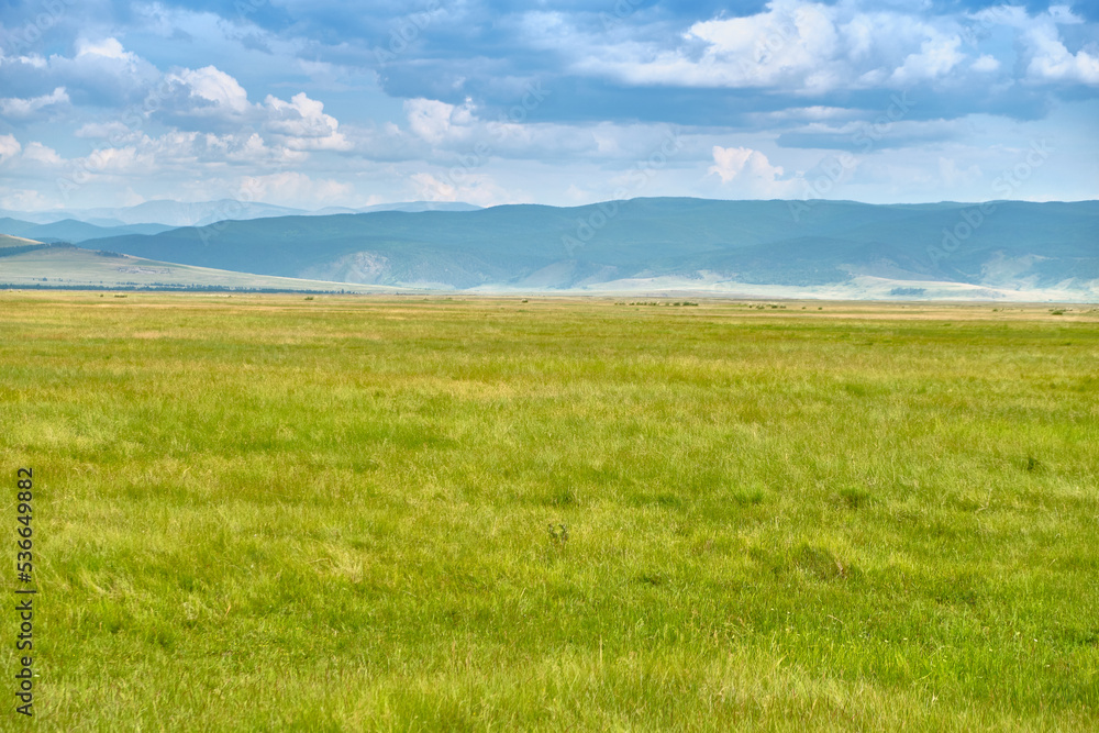 Steppe in the Barguzin Valley of the Republic of Buryatia on a clear sunny day. Steppe in the Barguzin Valley of the Republic of Buryatia on a clear sunny day.