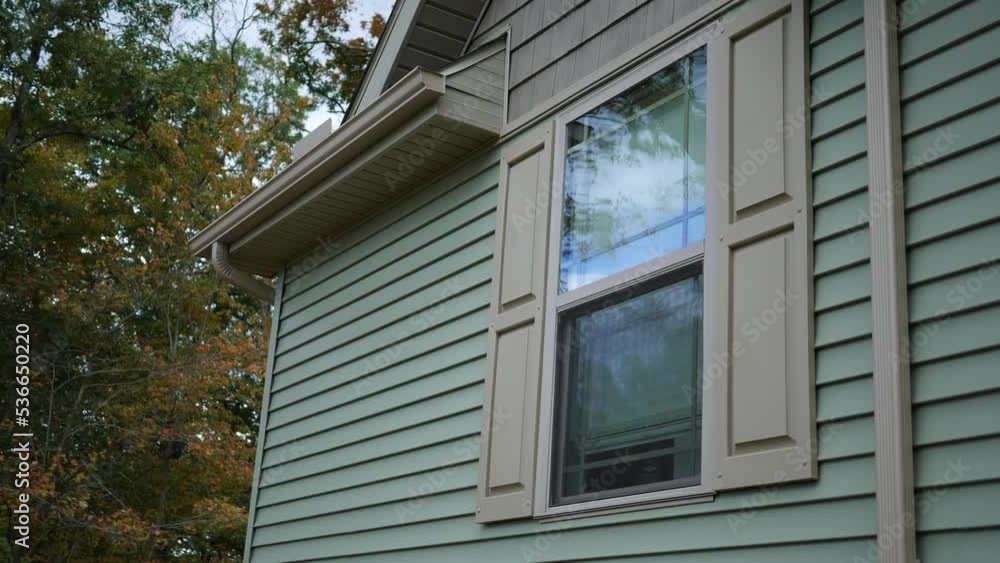 A window of a modern luxury home near forest in autumn A window of a modern luxury home near forest in autumn