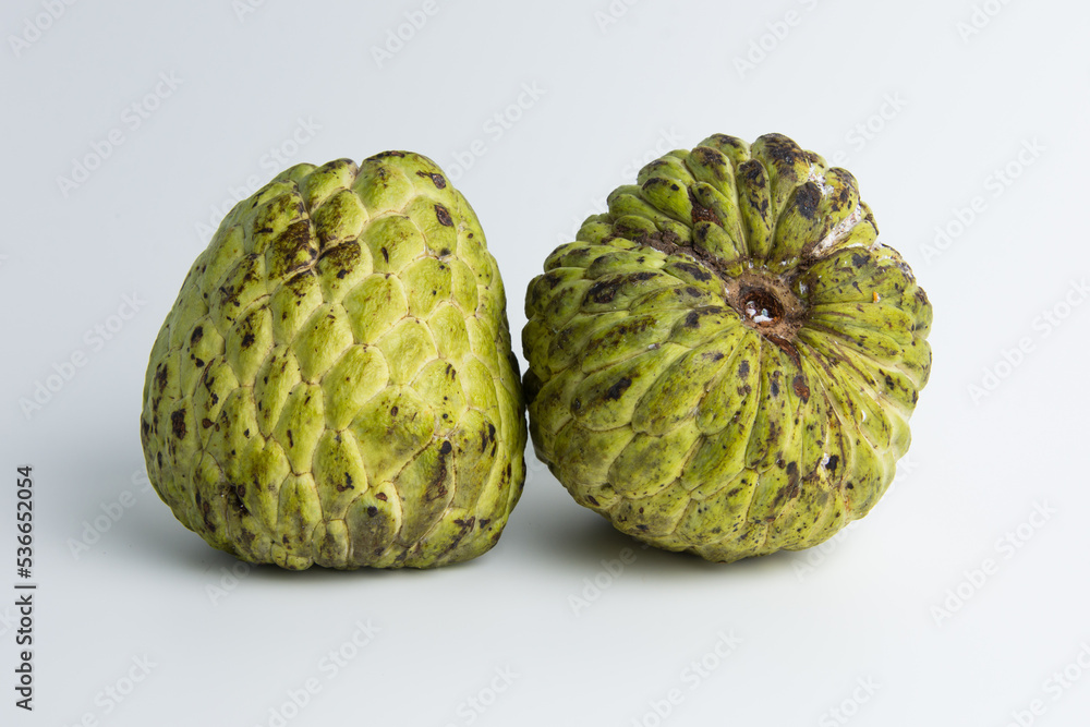 Obraz premium sugar apple ( srikaya ) with black spots, isolated on a white background, sugar apple fruit tastes sweet, grows in the tropics. can be eaten directly when it is ripe or can be processed first.