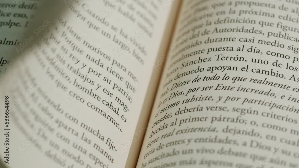 Flipping Spanish language book pages, reading and education, Flicking Through Old textbook Close-up, macro shot of paper in university library. Flipping Spanish language book pages, reading and education, Flicking Through Old textbook Close-up, macro shot of paper in university library.
