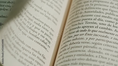 Flipping Spanish language book pages, reading and education, Flicking Through Old textbook Close-up, macro shot of paper in university library. photo
