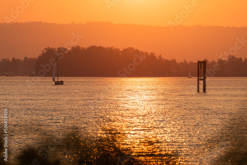 Glowing orange October sunset over sailboats and waters edge on the beautiful Columbia River, Vancouver Washington and Portland Oregon