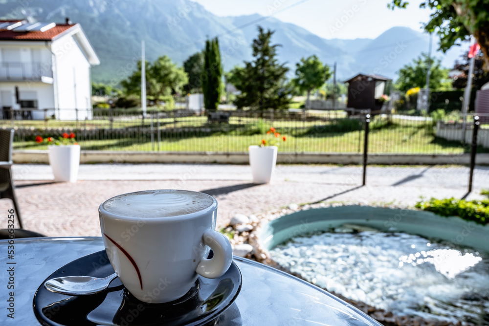 a cup of coffee in a cozy summer morning in the mountain