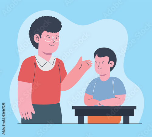teacher with schoolboy in desk