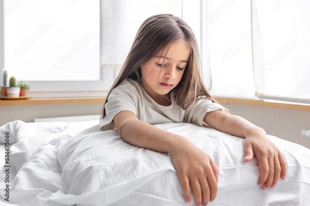Adorable little girl in her bed early in the morning. Adorable little girl in her bed early in the morning.