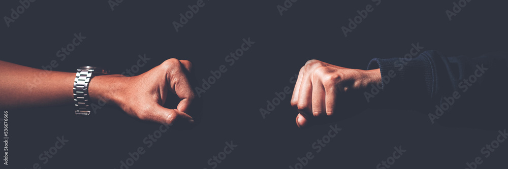
A shot crop of two fists smashing into each other to greet, challenge, fight, and duel. - obrazy, fototapety, plakaty 
