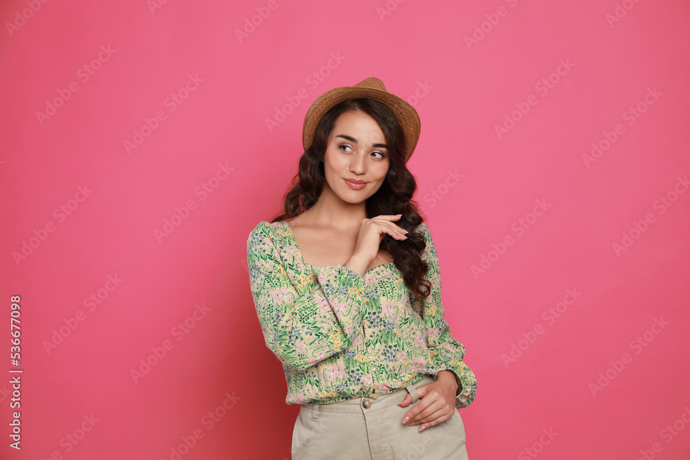 Beautiful young woman with straw hat on pink background Beautiful young woman with straw hat on pink background