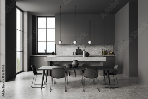 Grey kitchen interior with chairs and table, dining area and panoramic window